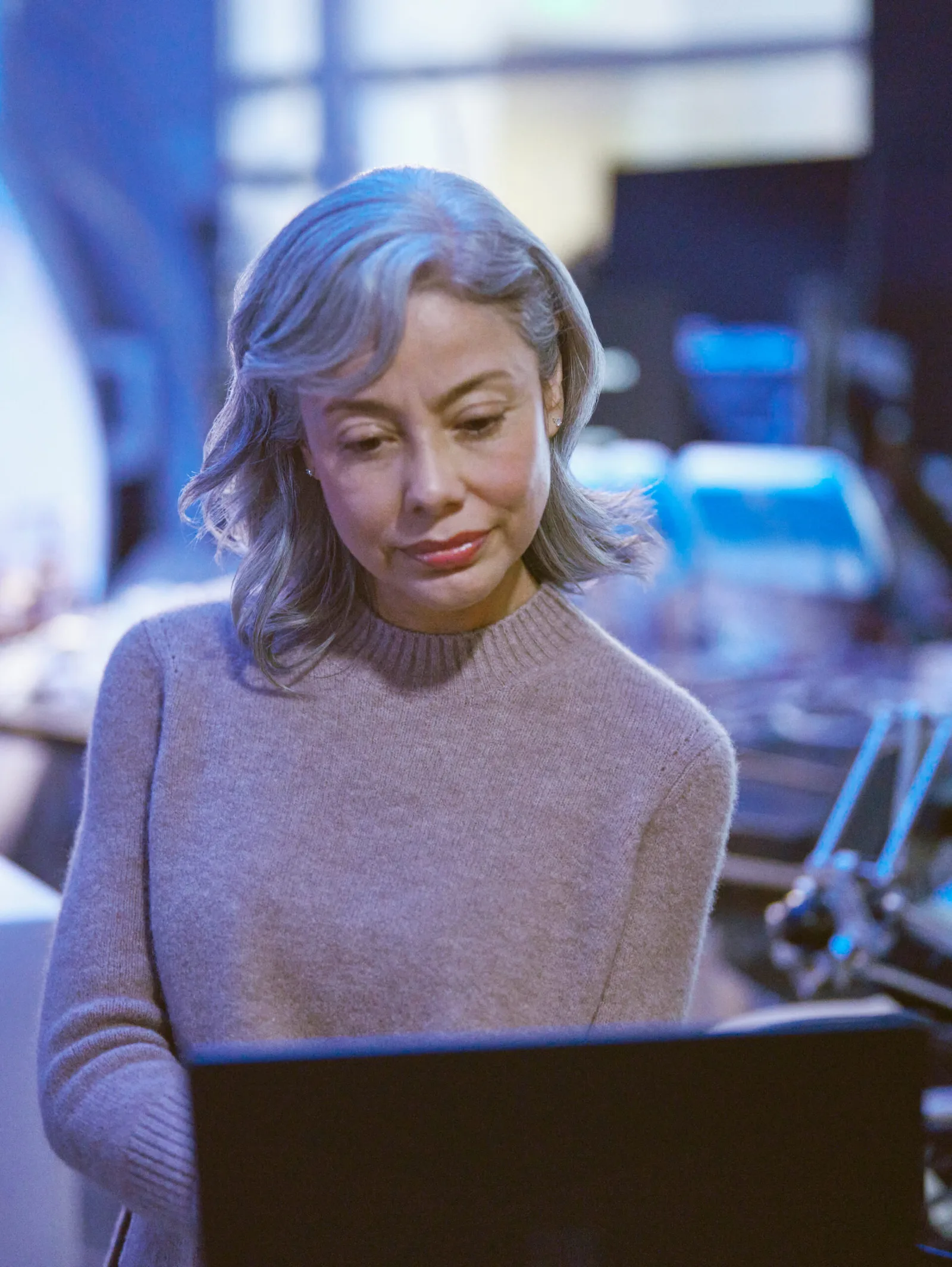 person looking ta the laptop screen in scientific setting