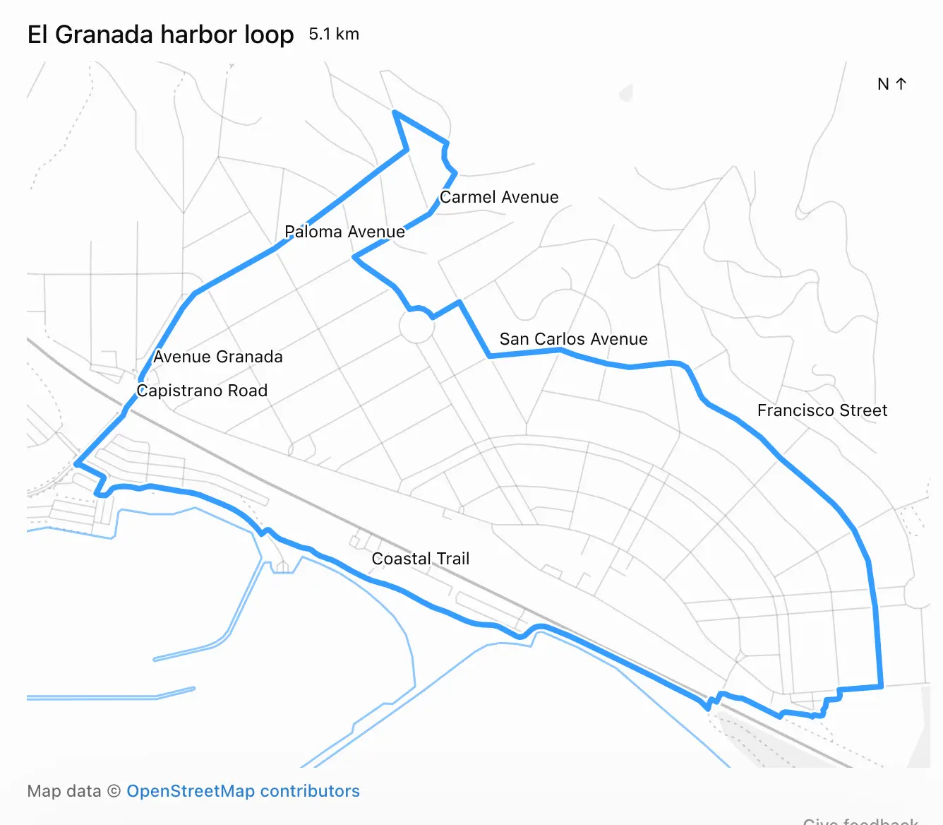 Map screenshot showing a blue route line over a light grey street map. Text: El Granada harbor loop 5.1 km. N ↑ (top right). Street labels along the route: Carmel Avenue, Paloma Avenue, San Carlos Ave
