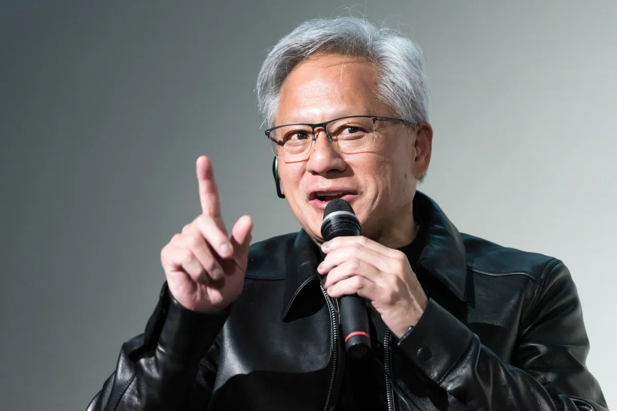 Huang Discusses AI Safety with Trump, Showcases New Apple Device